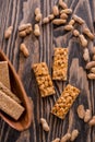 Snacks - mix of energy bars with peanut, sesame and sunflower seeds on a wooden background. Nuts in caramel, honey Snack food. Unh Royalty Free Stock Photo