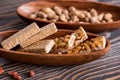 Snacks - mix of energy bars with peanut, sesame and sunflower seeds on a wooden background. Nuts in caramel, honey Snack food. Unh Royalty Free Stock Photo