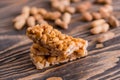 Snacks - mix of energy bars with peanut, sesame and sunflower seeds on a wooden background. Nuts in caramel, honey Snack food. Unh Royalty Free Stock Photo