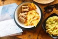 Snacks: Nachos chips and guacamole on the table