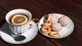 Snacks and sweets for tea in a small white saucer. Beautiful tea set. White ceramic Cup of tea with lemon on a wooden table Royalty Free Stock Photo