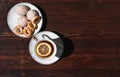 Snacks and sweets for tea in a small white saucer. Beautiful tea set. White ceramic Cup of tea with lemon on a wooden table Royalty Free Stock Photo