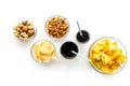 Snacks for TV watching. Chips, nuts, soda, rusks on white background top view