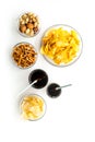 Snacks for TV watching. Chips, nuts, soda, rusks on white background top view