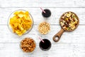 Snacks for TV watching. Chips, nuts, soda, rusks on white wooden background top view