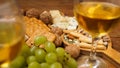 Snacks for wine. Cheese plate. Cheese, nuts, grapes, crackers Royalty Free Stock Photo