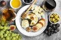 Snacks with wine - various types of cheeses, figs, nuts, honey, Royalty Free Stock Photo