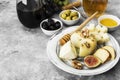 Snacks with wine - various types of cheeses, figs, nuts, honey,