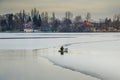 Snagov lake during wintertime.Clouds, sky, reflections. Gorgeous landscape in Bucharest.Frost on the surface.Fishing time