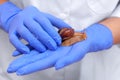 Snail ahaatin on the hand of a beautician close-up. Royalty Free Stock Photo