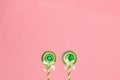 snail at the bottom pink background of two paper lollipops, creative minimal concept, art design Royalty Free Stock Photo