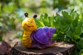 Snail garden figure on a stump Royalty Free Stock Photo