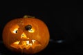 Snail on the ominous glow from inside an orange pumpkin