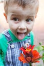 SNAIL ON RED FLOWER. Happy little boy playing in the park with snail at the day time. Selective focus. Royalty Free Stock Photo