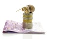 Snail sitting on top of stack of euro coins Royalty Free Stock Photo