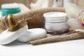 Snail, spa stones and cream on white table, closeup Royalty Free Stock Photo