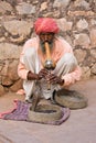 Snake charmer is playing the flute for the cobra in Jaipur, India