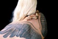 Snake on female shoulder and back, part woman body. Boa constrictor snake crawling per womanÃ¢â¬â¢s back, shoulder, tattoo.