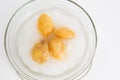 Snake fruit in syrup with ice in a glass bowl