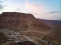 Snake trail to climb the ancient fortress of Masada. The beginning of the pedestrian road. Modern building in the desert. Judean