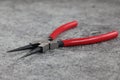 Snap ring pliers with red handles on grey background Royalty Free Stock Photo