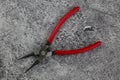 Snap ring pliers with red handles on grey background Royalty Free Stock Photo