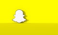 Snapchat logo on yellow wall background with hard shadow and space for text and graphics