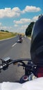 Snapshoot while riding a motorcycle on the road, blue sky