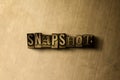 SNAPSHOT - close-up of grungy vintage typeset word on metal backdrop