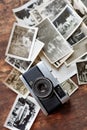 Snapshots from the past. An old-fashioned camera lying on top of a pile of black and white photographs. Royalty Free Stock Photo