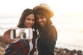 Snapshots of summer memories. two young friends taking a selfie together at the beach. Royalty Free Stock Photo