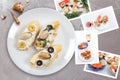 Snapshots of various sandwiches with seafood arranged on rustic wooden background with plates with food and seashells Royalty Free Stock Photo