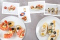 Snapshots of various sandwiches with seafood arranged on rustic wooden background with plates with food and seashells Royalty Free Stock Photo