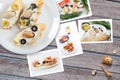 Snapshots of various sandwiches with seafood arranged on rustic wooden background with plates with food and seashells Royalty Free Stock Photo