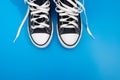 Sneackers lying on blue background. Top view. Flatlay. Copyspace center Royalty Free Stock Photo