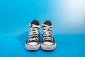 Sneackers lying on blue background. Top view. Flatlay. Copyspace center Royalty Free Stock Photo