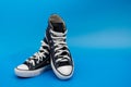 Sneackers lying on blue background. Top view. Flatlay. Copyspace center Royalty Free Stock Photo