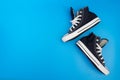 Sneackers lying on blue background. Top view. Flatlay. Copyspace center Royalty Free Stock Photo