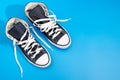 Sneackers lying on blue background. Top view. Flatlay. Copyspace center Royalty Free Stock Photo