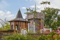 Sneak Peak of the Gatherning Place - Unique community riverfront park - Senior couple stand on bridge looking at castle playhouses Royalty Free Stock Photo