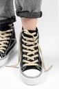 Sneaker with untied laces on a female leg on a white background Royalty Free Stock Photo