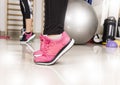 Sneaker of young woman stretching leg in gym,Sport concept. Close up of female feet in sneakers in gym.