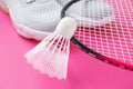 Sneakers, badminton rackets and shuttlecock on a bright pink background. Royalty Free Stock Photo