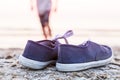 Sneakers at the beach with running boy Royalty Free Stock Photo