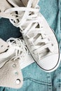 sneakers on blue jeans close-up Royalty Free Stock Photo