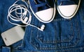 Sneakers, blue jeans and gadgets. Royalty Free Stock Photo