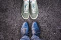 Sneakers and business shoes face to face on asphalt, work life balance concept Royalty Free Stock Photo