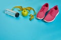 Sneakers, centimeter, green apple, weight loss, running, healthy eating, healthy lifestyle concept Royalty Free Stock Photo