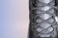 Sneakers close-up. Shoelaces of new sports shoes in gray, lacing sneakers close-up, top view. Mesh elastic laces for