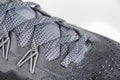 Sneakers close-up. Shoelaces of new sports shoes in gray, lacing sneakers close-up, top view. Mesh elastic laces for fitness.